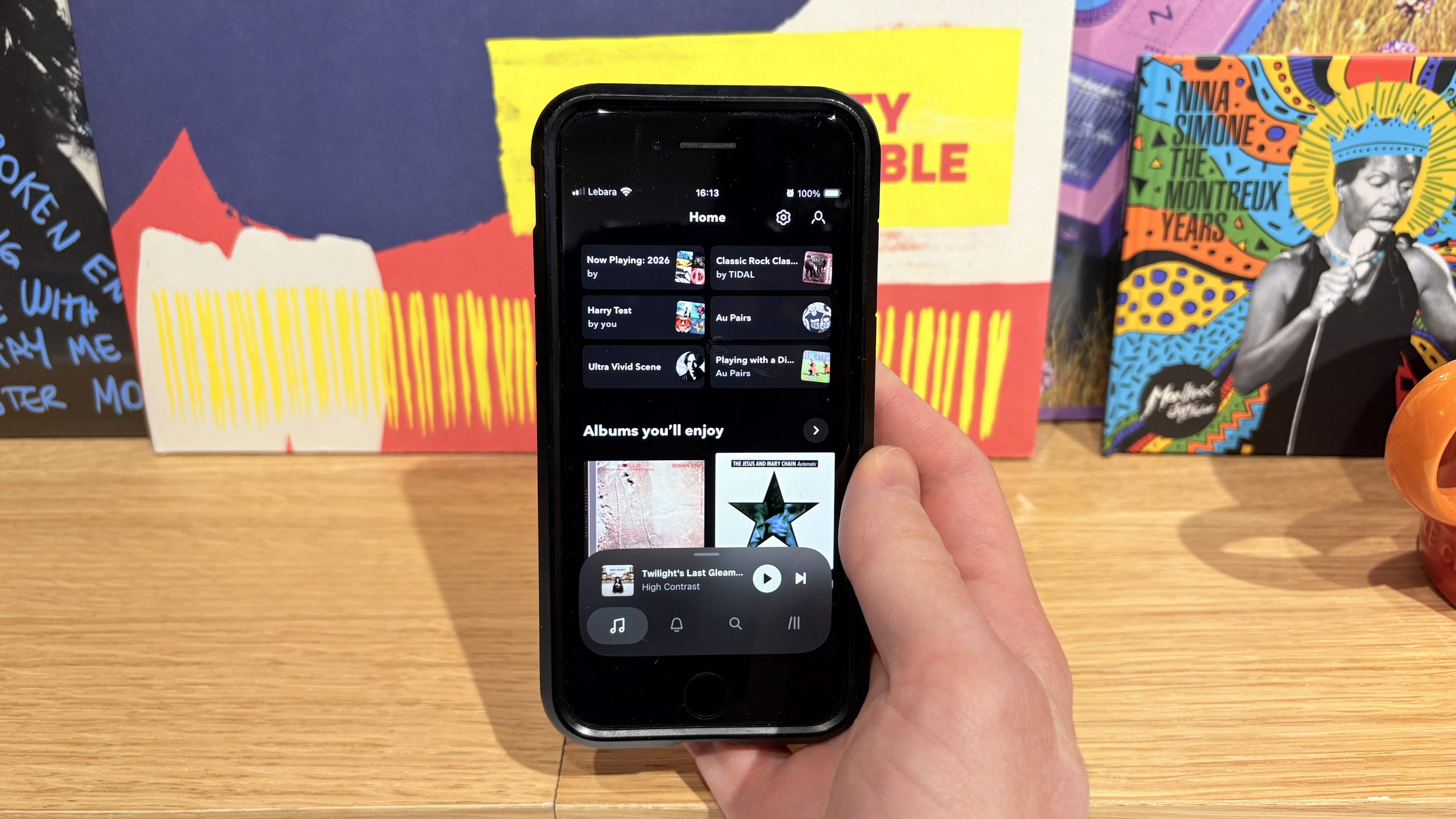 Hands-on shot of Tidal playing on an iPhone