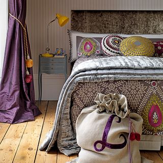 bedroom with folk-inspired prints and mix and match intricate motifs for an eclectic feel then add pops of warm yellow green and pink to break up the pattern
