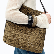 woman wearing a raffia bag and bangles 