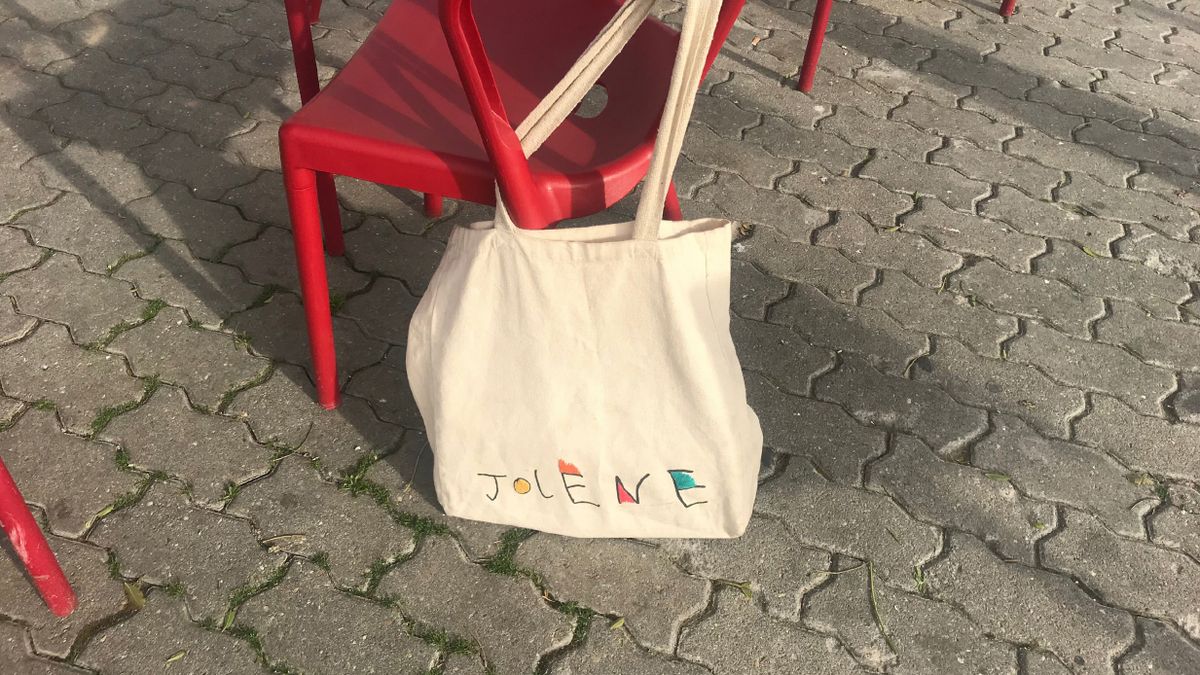 Variations of the logo appear on tote bags, menus, and more
