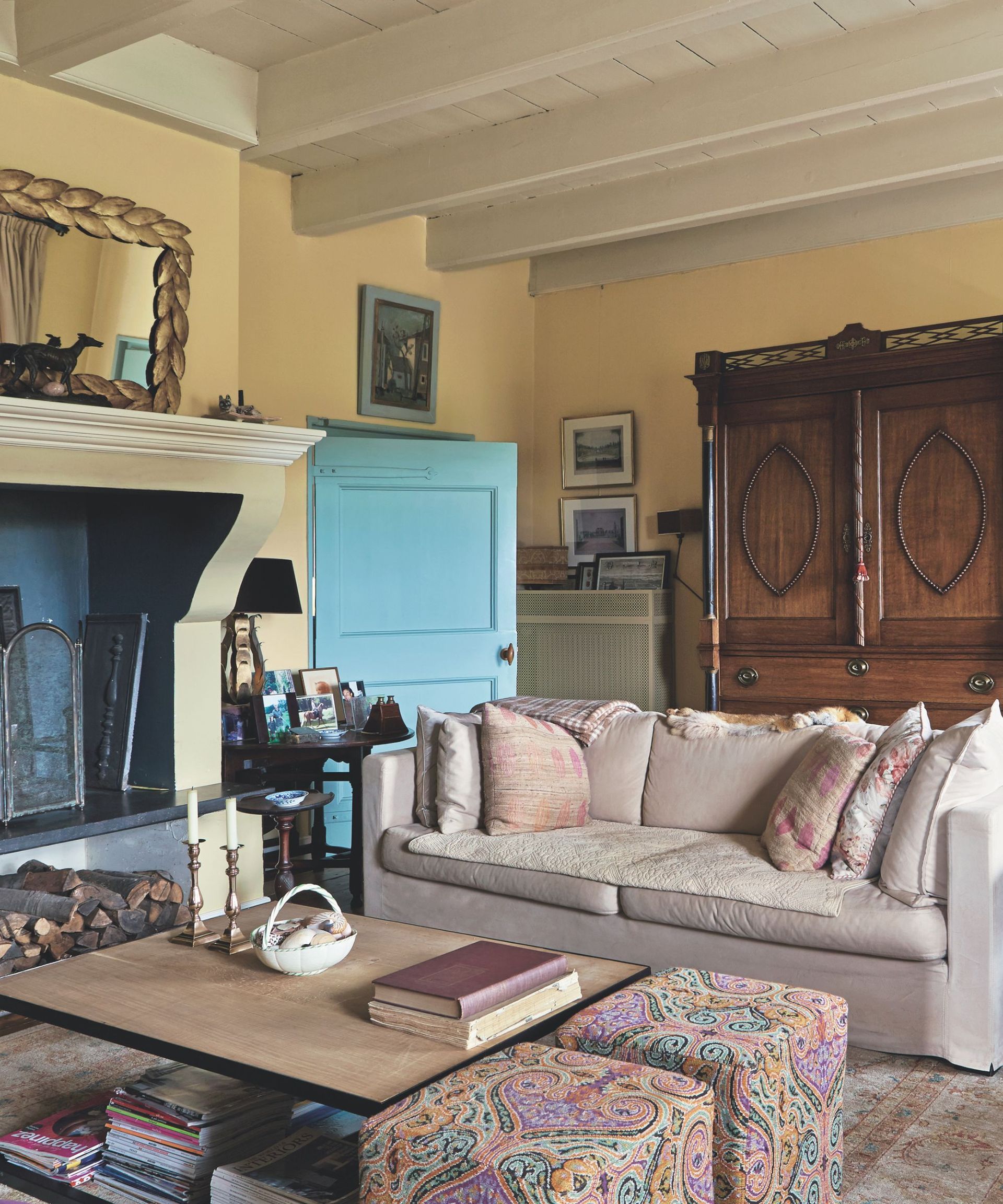 A traditional sitting room filled with various pieces of furniture. The walls are painted in a pale yellow.