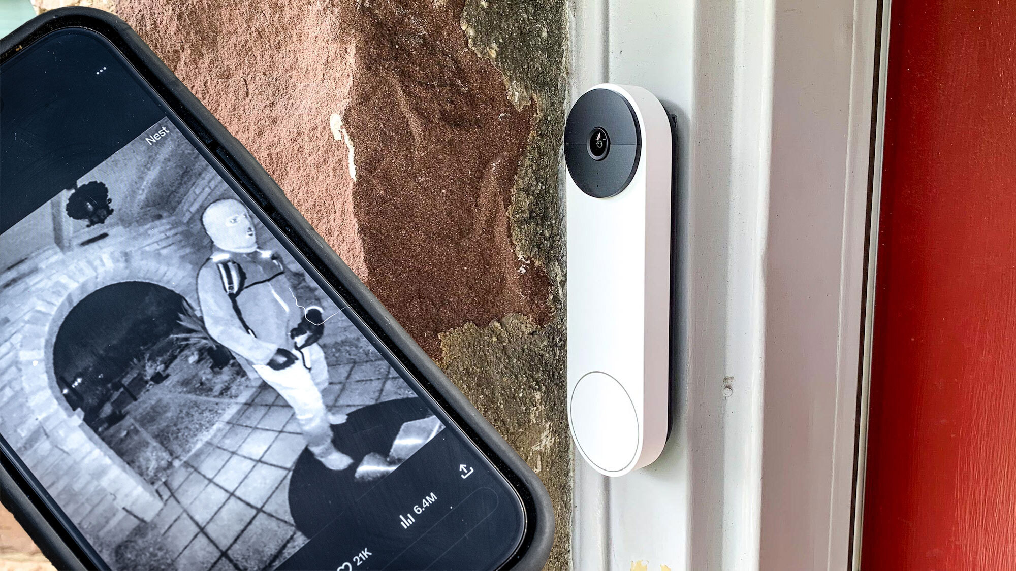 A smartphone showing images captured by Nancy Guthrie's video doorbell next to Nest Doorbell (battery) mounted outside a home