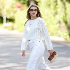 Sofia Richie Grainge wearing a white sweater and jeans