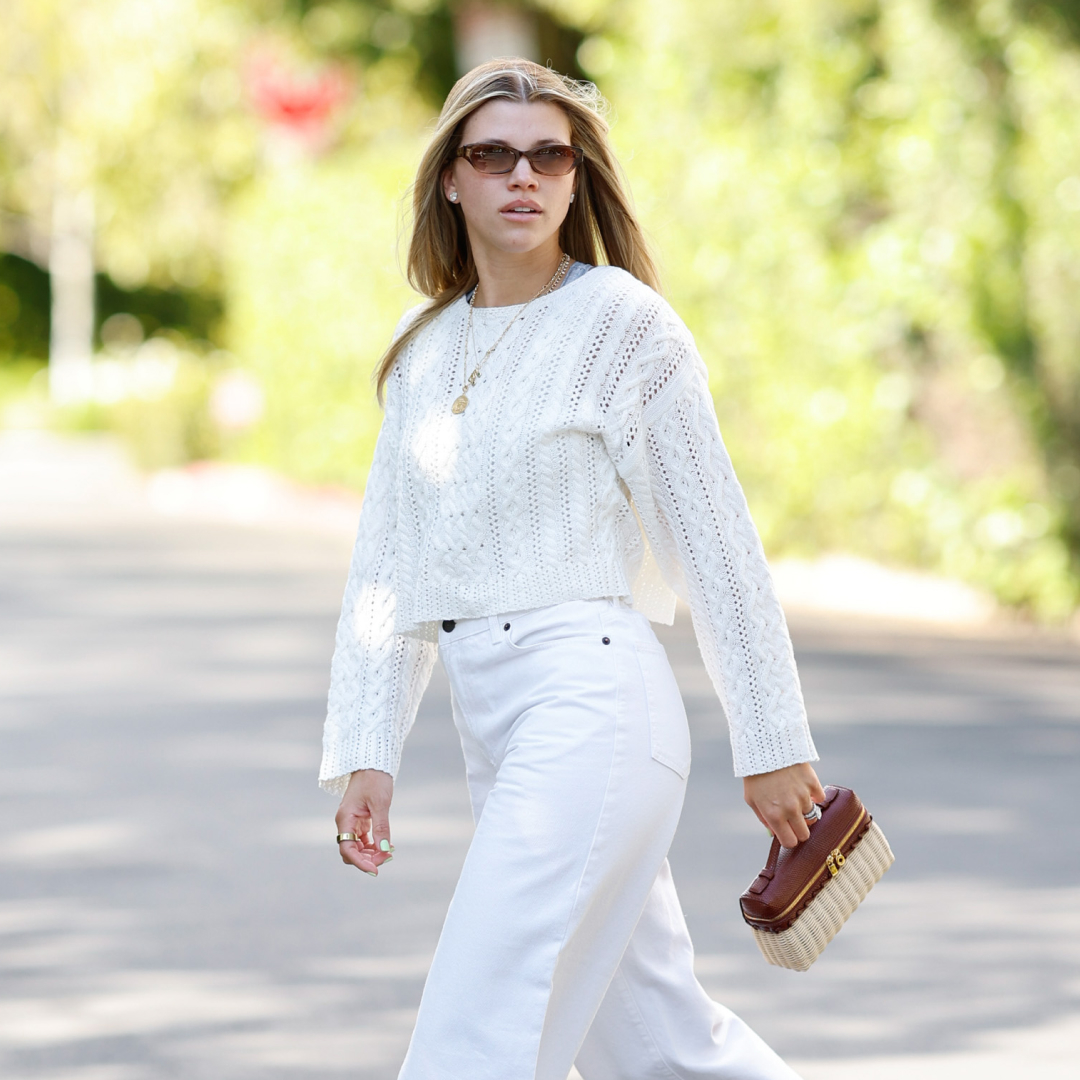 Sofia Richie Grainge wearing a white sweater and jeans