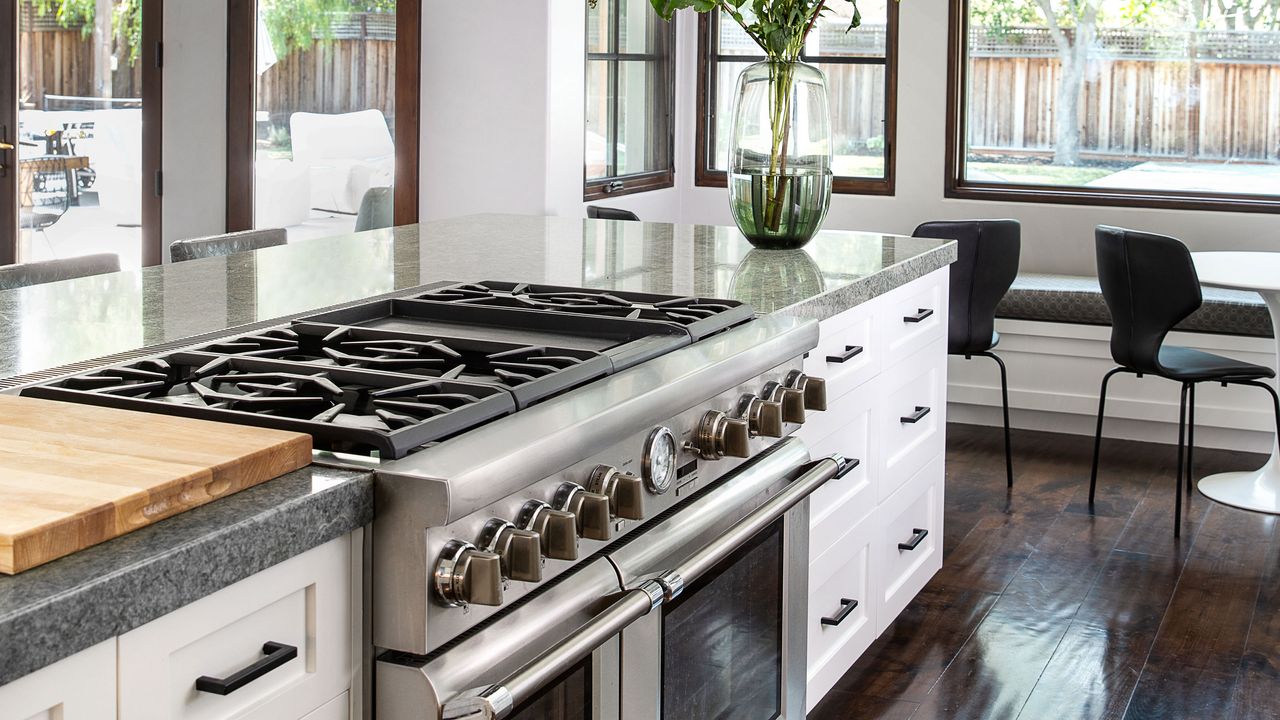 white kitchen with oven and gas stove