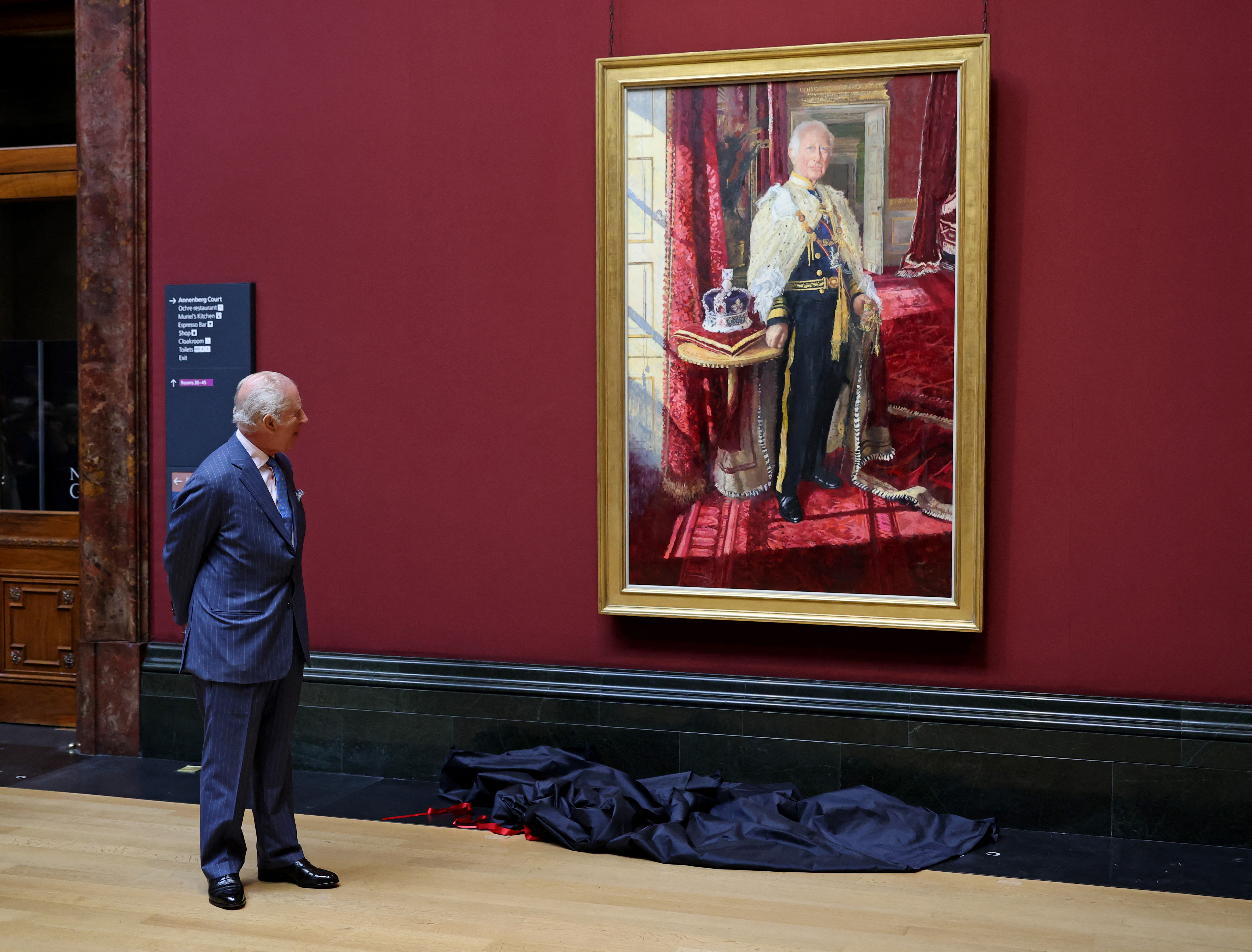 King Charles III looks at his official Coronation State Portrait, by artist Peter Kuhfeld, after unveiling it during a visit to The National Gallery, in central London, on May 6, 2025