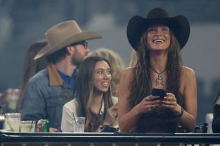 Bella Hadid appears at a rodeo to cheer on her boyfriend wearing a cowboy hat
