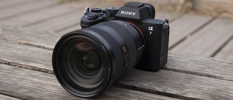The Sony A7 IV camera sitting on a wooden bench