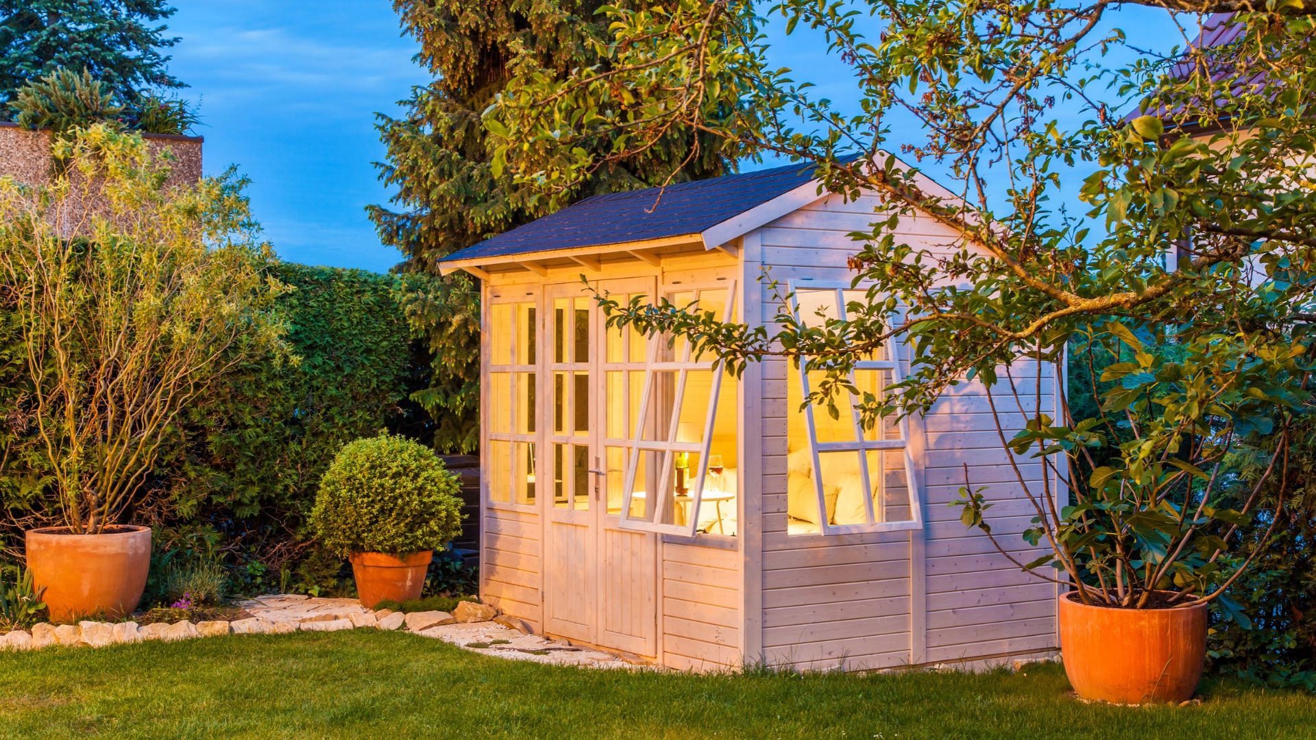 picture of wooden shed with windows open in garden