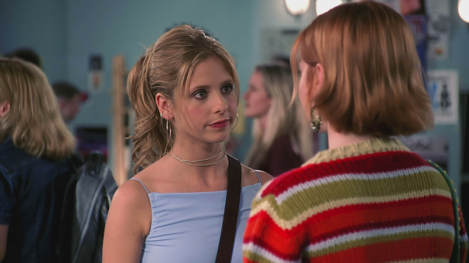 Buffy and Willow standing in a college hallway