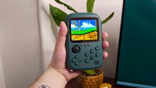 Hand holding DY19 retro handheld with Sonic 2 on screen