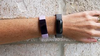 Fitbit Inspire HR (left) and Fitbit Luxe (right) worn on one hand together
