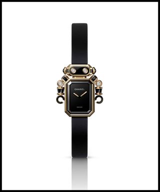 An image of the Chanel Première Robot Watch with a striking and playful Robot design with black watch face and gold detailing
