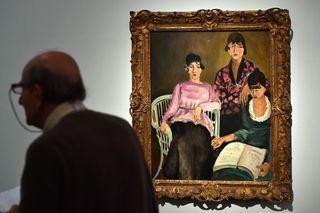 A man stands near a Henri Matisse painting on display in Italy