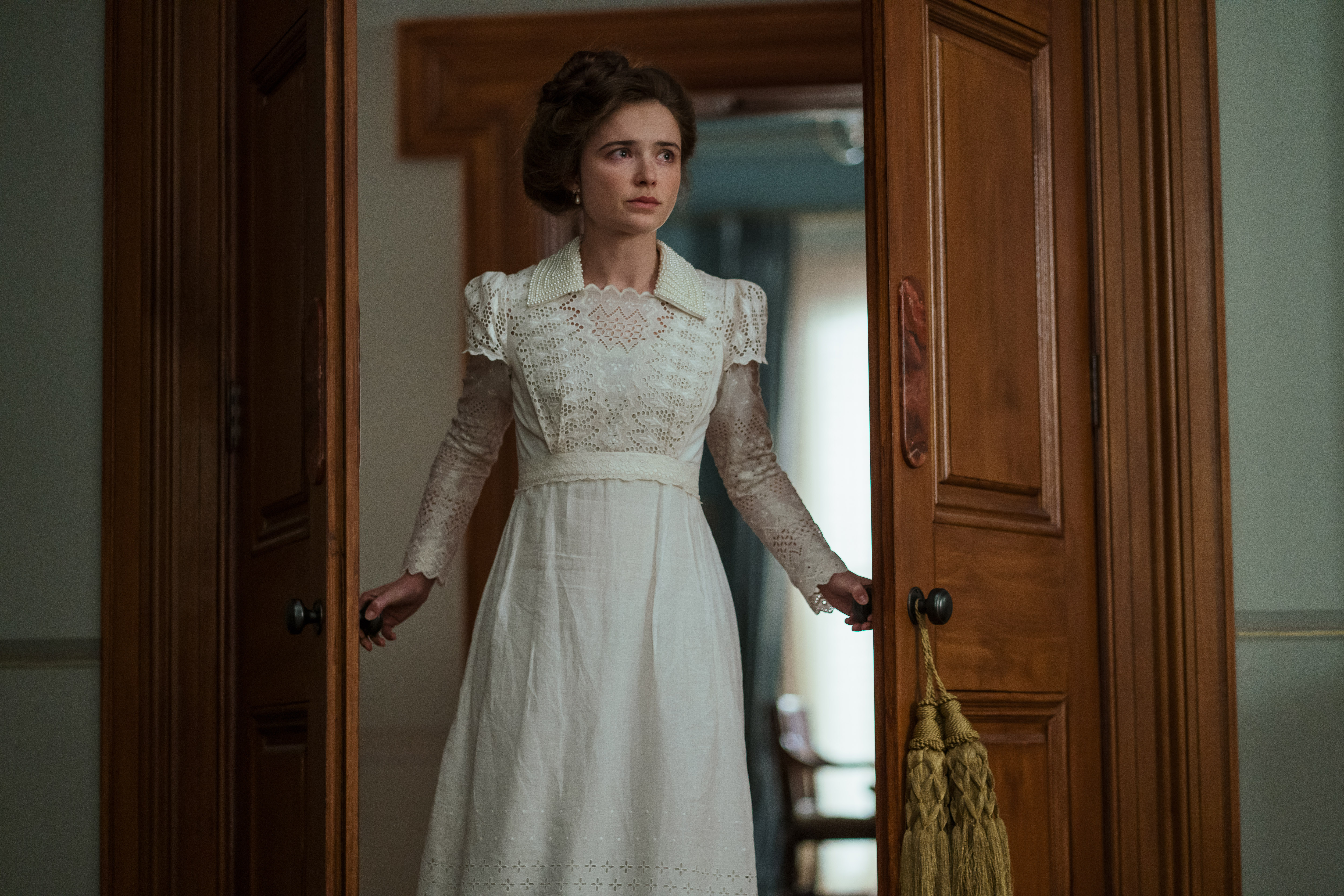 Phillipa Northeast as Sybylla, wearing a white gown, in the Netflix period drama 'My Brilliant Career.'