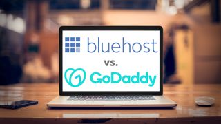 Bluehost and GoDaddy logo on a laptop screen on a desk