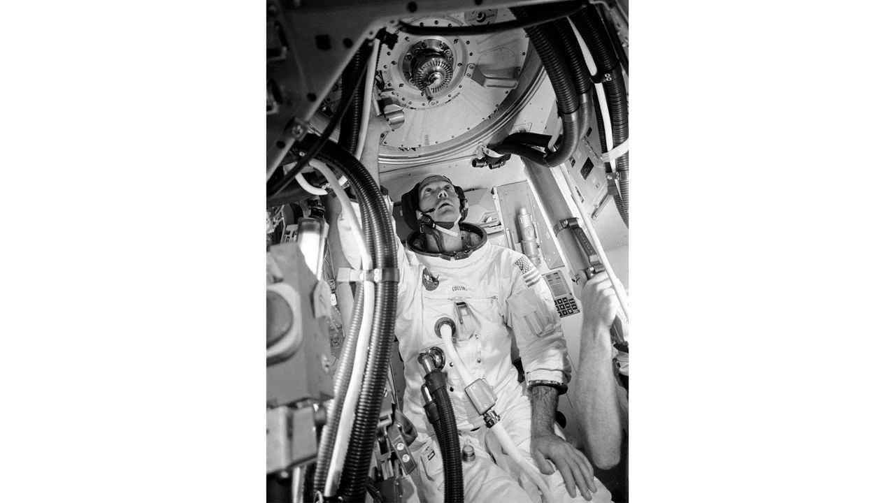 Astronaut Michael Collins is pictured inside a mockup Apollo command module before the Apollo 11 flight.
