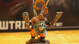 A fully-painted Ogor Mawtribes Glutton model bears his weapons and yells