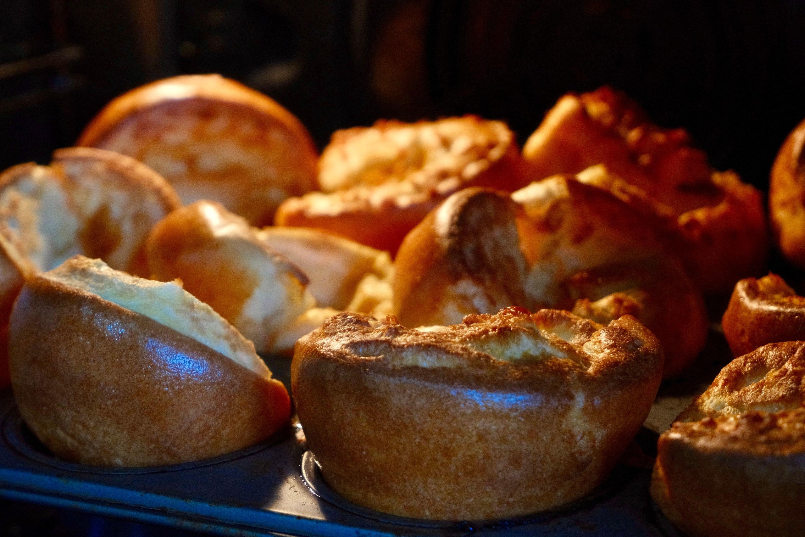 Yorkshire puddings cooking in an oven