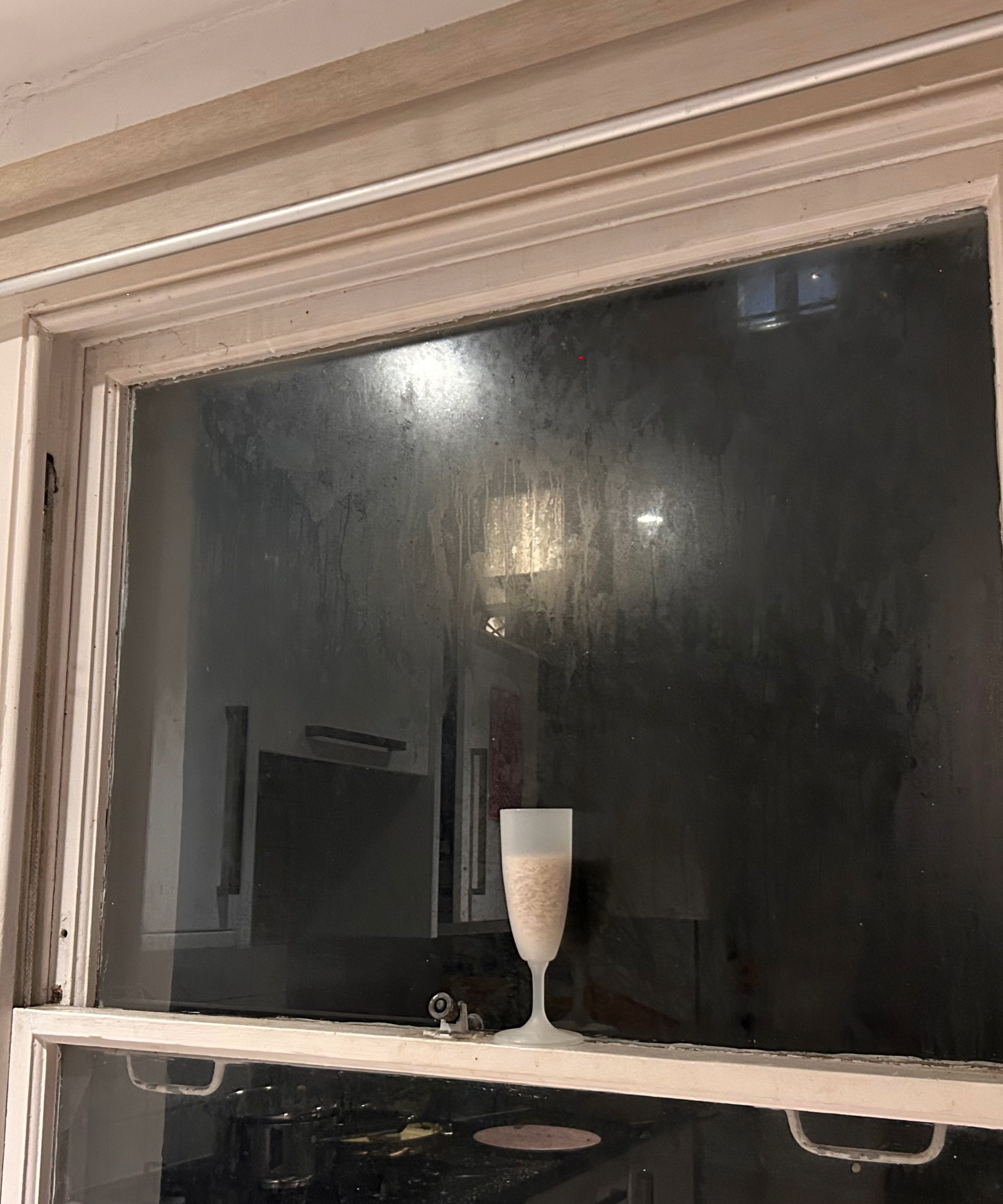 Champagne flute of rice on a condensation window