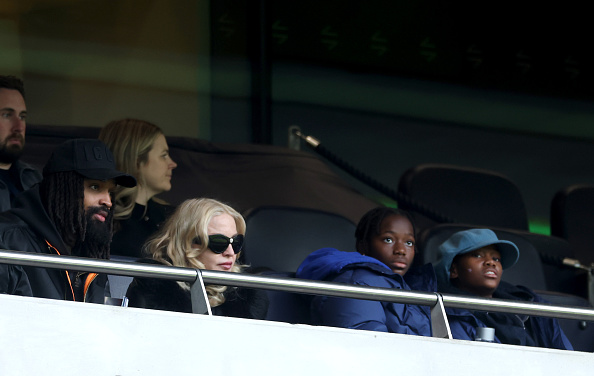 LONDON, ENGLAND - FEBRUARY 08: Madonna, American singer-songwriter and record producer, and Akeem Morris, watch on from the stands during the Barclays Women's Super League match between Tottenham Hotspur and Chelsea FC at BetWright Stadium on February 08, 2026 in London, England. 