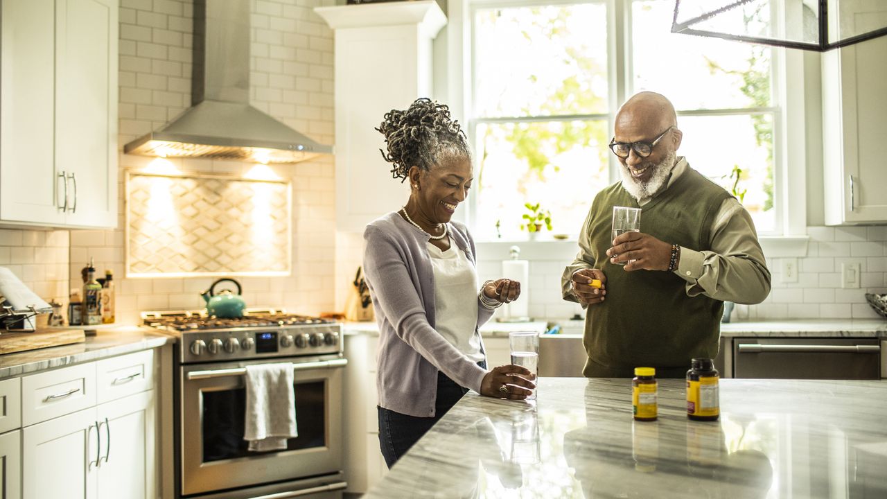 Two people taking vitamin D supplements