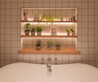 white tiled wall with inset shelving feature, wooden shelves, decorative items and LED strip accent lights