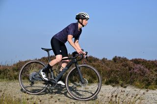 Cyclist riding the Canyon Grail CF SL AXS gravel bike on a UK gravel trail