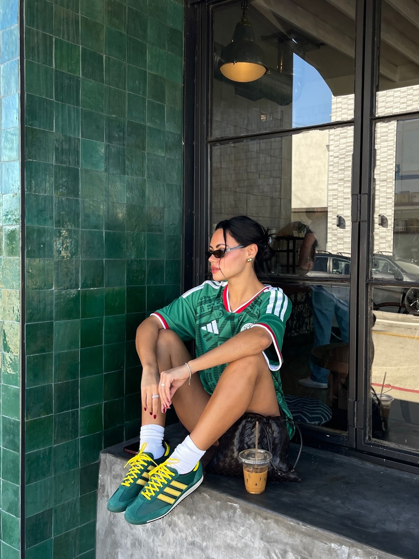 @michelleinfusino wearing green and yellow Adidas sneakers