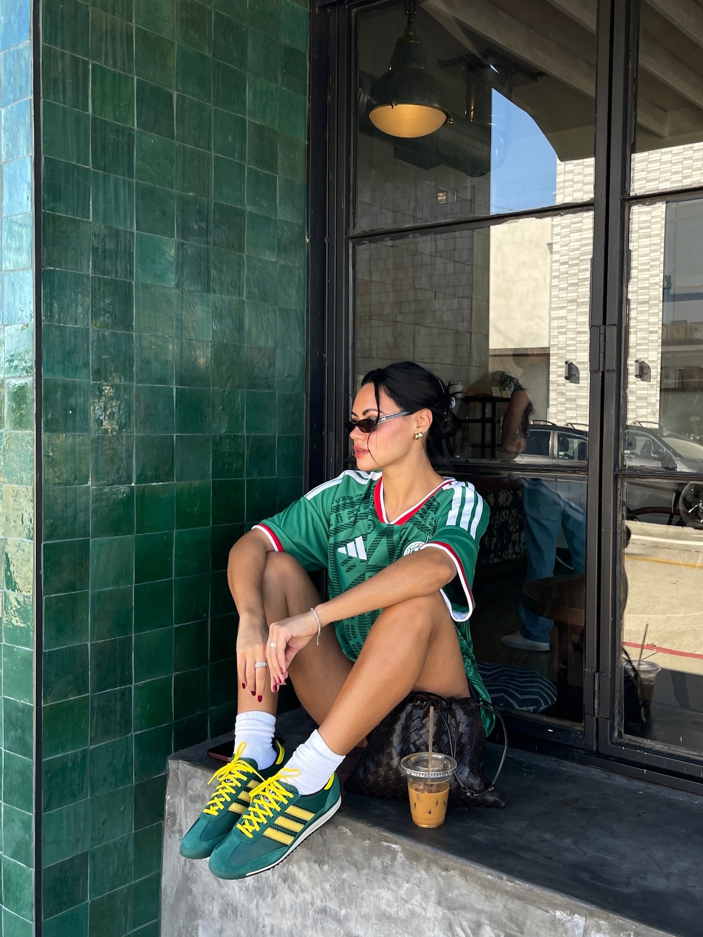 @michelleinfusino wearing green and yellow Adidas sneakers