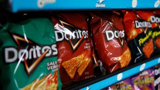 Packages of Doritos chips are displayed on a store shelf on April 23, 2025 in San Anselmo, California. Health and Human Services Secretary Robert F. Kennedy Jr. announced plans to phase out all artificial dyes from the food supply by the end of 2026. The Food and Drug Administration is directing the food industry to replace petroleum-based synthetic dyes with natural alternatives