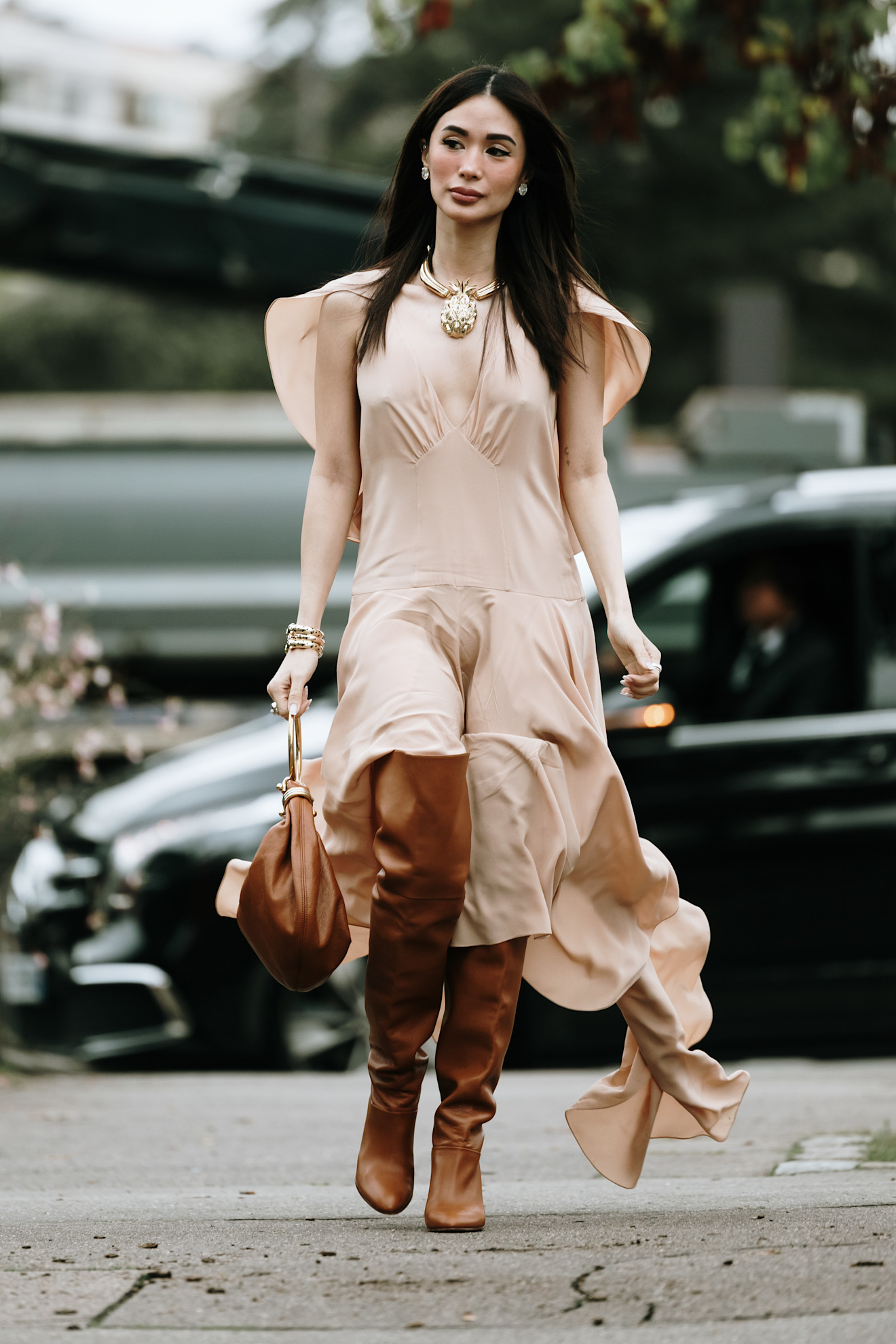 Fashion week boho street style outfit with light brown leather knee boots