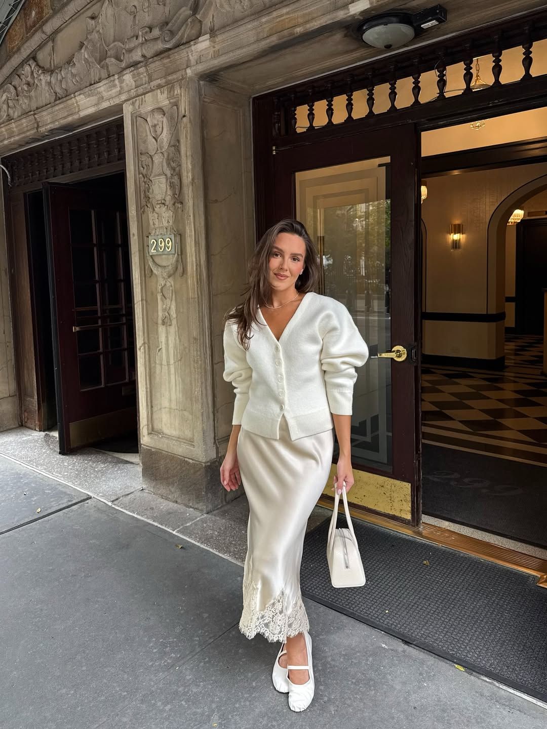 Emma in white cardigan and slip skirt