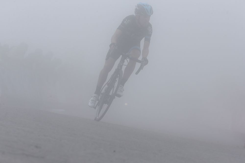 A rider heads through the mist on stage 14 of the Vuelta a Espana