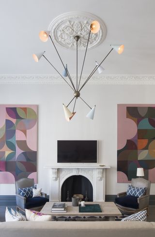 white living room with statement lighting ceiling pendant and art by Kitesgrove