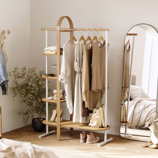 Freestanding clothes rail storage unit in bedroom