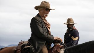 Sam Elliott on a horse with LaMonica Garrett on a horse behind him.