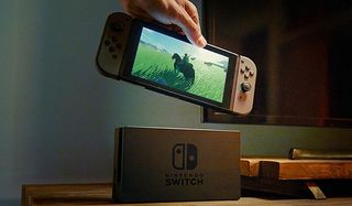hand lifts nintendo switch from its dock