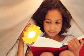 Little girl reading with Little Sun Original, Image © Franziska Russo
