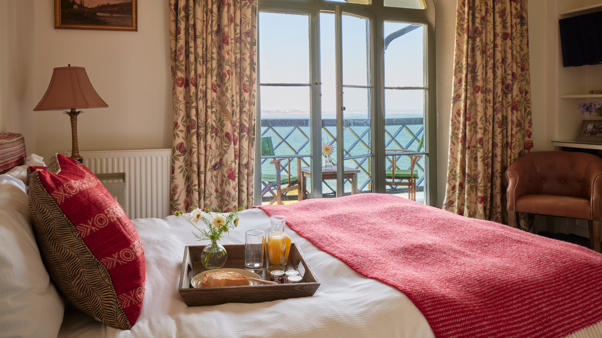Cary Arms and Spa bedroom with tray of breakfast and views out to sea.