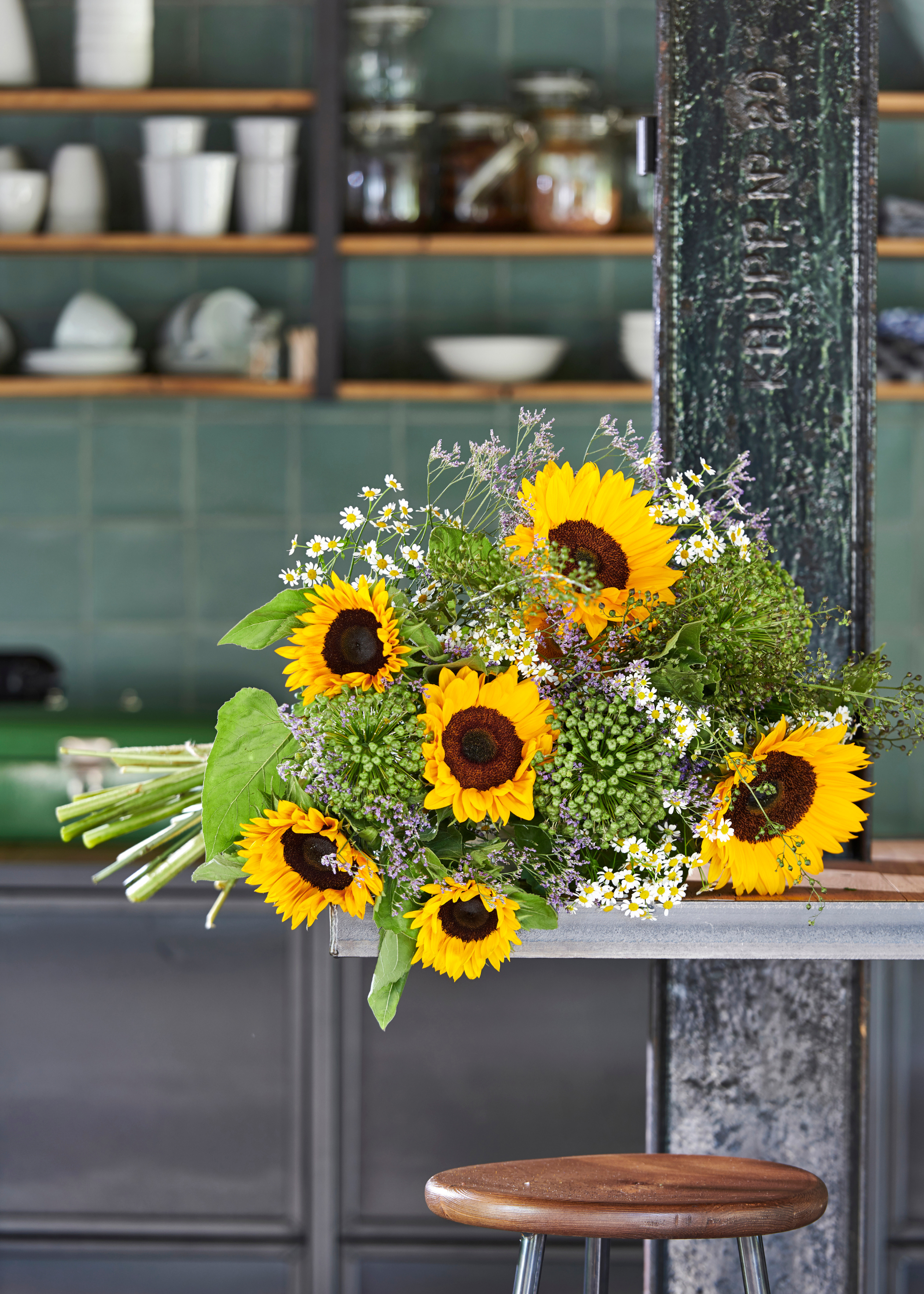 A bouquet of sunflowers on a kitchen countertop