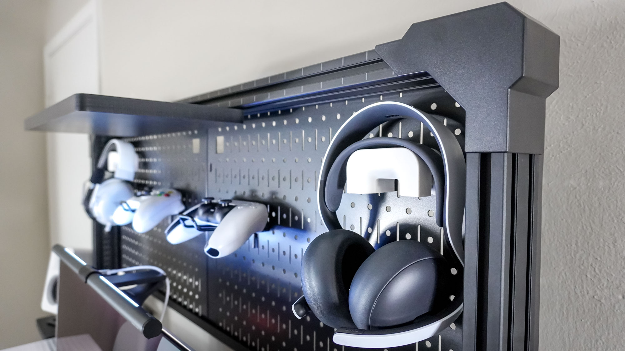 Corsair's Multi Frame Pegboard Desk Organizer with various gaming headsets and controllers stored at the top