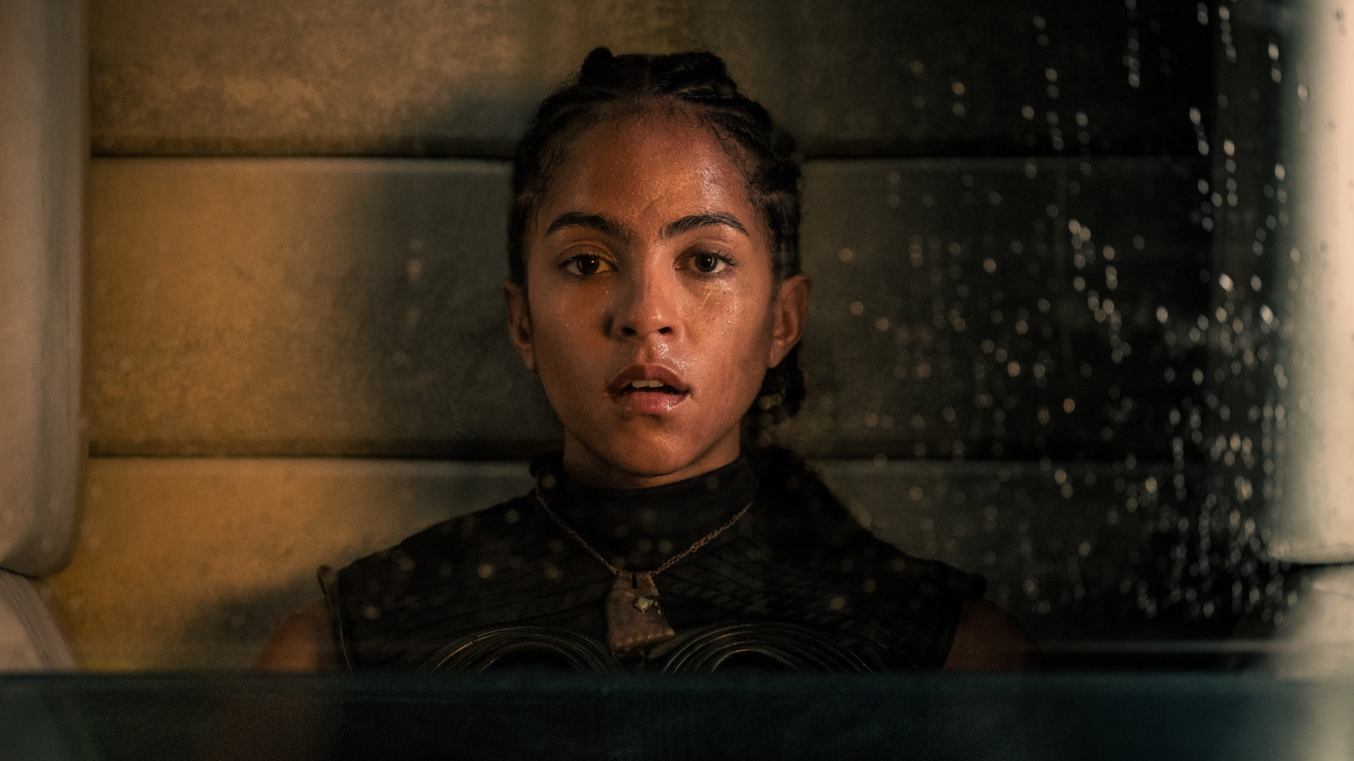 a young woman staring in awe in a confined place