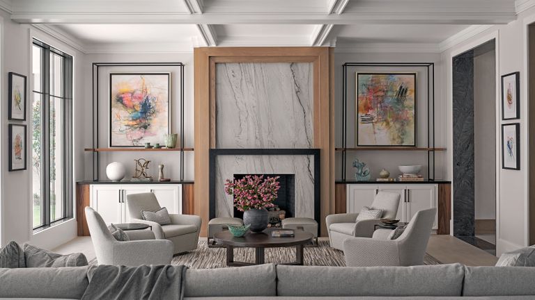 living room with gray furniture and marble fireplace armchairs and bright artworks