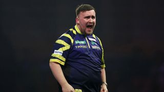 Luke Littler celebrates after winning a leg against Ryan Searle in the semifinal of the World Darts Championship 2026