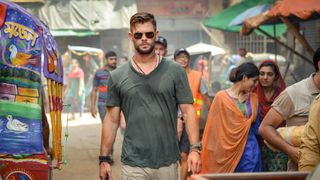 Chris Hemsworth walking down a street in Netflix's Extraction.