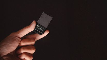 WD_Black C50 being held in front of a black background