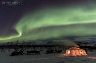 The northern lights glow over Abisko, Sweden in this view by photographer Oliver Wright taken on March 14, 2018.
