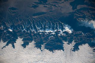 A photo of Earth taken from the International Space Station reveals the frigid mountain tops of the Andes in South America. Tomorrow (July 2), a total solar eclipse will pass over this mountain range.