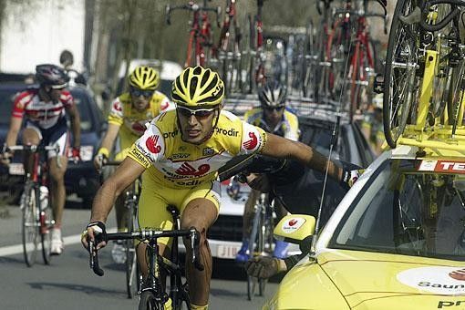 A Saunier Duval mechanic works on a riders' bike after a crash. Hope that leg got some attention too!